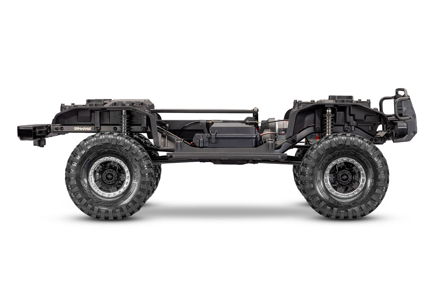 Side view of Traxxas TRX-4 Nissan Pathfinder RC crawler chassis showing detailed suspension and rugged design.