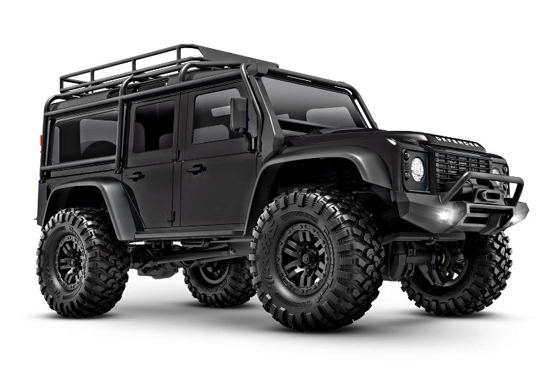 Traxxas TRX-4M Land Rover Defender RC scale model vehicle, front three-quarter view with detailed black exterior.