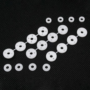 Xpress Composite 1.1mm Hole Piston and Spacer Set showing metallic pistons and spacers with detailed components.