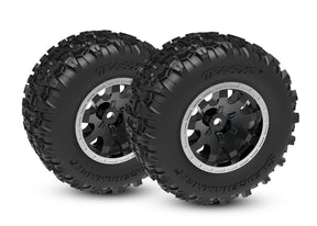 Traxxas Mini Maxx and XRT 4-inch rear wheels with black tires and rims for off-road remote control trucks.