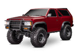 Red Traxxas TRX-4 Nissan Pathfinder radio-controlled scale off-road vehicle shown from a three-quarter front driver side angle.