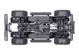 Traxxas TRX-4 Nissan Pathfinder RC truck chassis bottom view showing detailed suspension and drivetrain components.