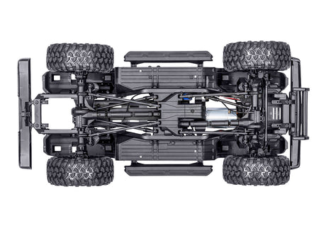 Traxxas TRX-4 Nissan Pathfinder RC truck chassis bottom view showing detailed suspension and drivetrain components.