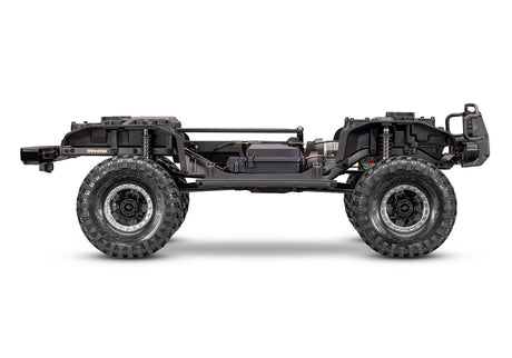 Side view of Traxxas TRX-4 Nissan Pathfinder RC crawler chassis showing detailed suspension and rugged design.