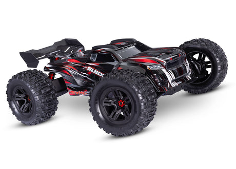 Traxxas 1/8 Sledge belted off-road RC truck showing front view with red body and RGB lighting details.