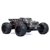 ARRMA Outcast 4X4 4S 1/10th scale 4WD stunt truck with rugged tires and aggressive design, ready for off-road action.
