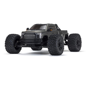 ARRMA 1/7 Big Rock 6S 4WD BLX RTR monster truck shown on rugged terrain with large tires and powerful suspension.