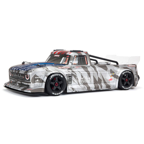 ARRMA 1/7 Infraction 6S AVC 4X4 RTR street basher RC car on a road surface with detailed body and large tires.