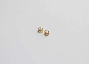 Reflex Racing RX28A-17-MS Medium Kiss Front Springs V2 for RC car, gold-colored suspension springs in close-up view.