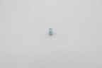Reflex Racing RX28A-06 soft center spring for RC cars, white silver color, close-up of spring on a reflective surface.