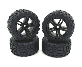 Four Rage RC Mini Trek MT wheels and tires for RC trucks, showing black wheels with rugged tires for off-road driving.